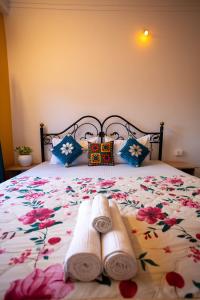 a bedroom with a bed with towels on it at Krishna Stay Guest House in Udaipur