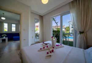 a bedroom with a bed with towels and a window at Legend Apartments II Fethiye in Fethiye +117 photos