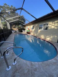a swimming pool in the middle of a house at Heated pool home only 2.3miles from the beach in St. Petersburg
