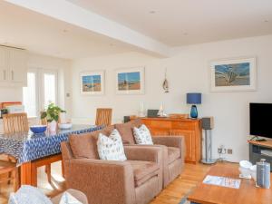 a living room with a couch and a table at 3 Bonaventure Close in Salcombe