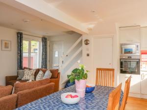 a living room with a table and a couch at 3 Bonaventure Close in Salcombe +16 photos