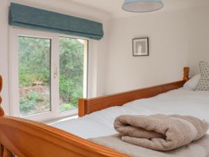 a bedroom with a bed with a towel on it at 3 Bonaventure Close in Salcombe