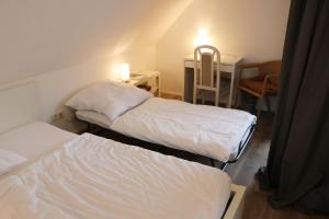 Postel nebo postele na pokoji v ubytování Messe- und Gästezimmer Hildesheim