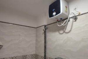 a bathroom with a soap dispenser on a wall at Compact yet beautiful 1bhk 305 in Bangalore