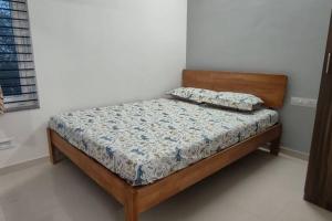 a bedroom with a bed with a wooden headboard at Compact yet beautiful 1bhk 305 in Bangalore