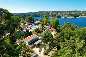 an aerial view of a house on the shore of a lake at Marti Watersports in Martinchel