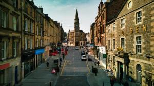 a city street with buildings and a clock tower at King Street Aparthotel in Stirling