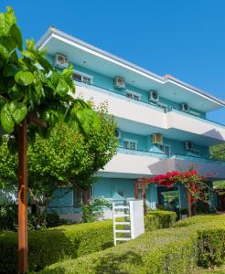 un bâtiment bleu avec une échelle devant dans l'établissement Armeno beach hotel, à Nydri