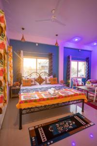 a bedroom with a bed in a room with purple walls at Krishna Stay Guest House in Udaipur