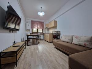a living room with a couch and a table at Cozy Apartment - Palas in Iaşi