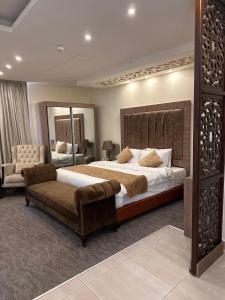 a large bedroom with a large bed and a couch at AlQimah Hotel Apartments in Amman +78 photos