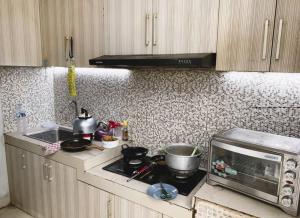 uma cozinha com um fogão e um micro-ondas em Felix guest house em Tegal