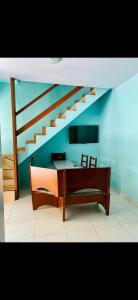 a room with a bed and a staircase at Casa de Temporada Arraial do cabo in Arraial do Cabo