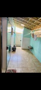 a room with a bathroom with a toilet and a tiled floor at Casa de Temporada Arraial do cabo in Arraial do Cabo