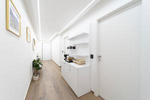 a hallway with white cabinets and a white door at Mentana Rooms - by Devona Rooms in Parma