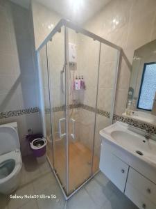 a bathroom with a shower and a toilet and a sink at The Naithorn Condo Unit 401 in Nai Thon Beach
