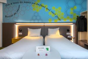 two beds with a sign that says on a bus for those who cannot sleep at ibis Styles Strasbourg Stade de la Meinau in Strasbourg