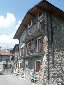 a stone building with a balcony on the side of it at Apartments Gravedona Panoramic in Gravedona