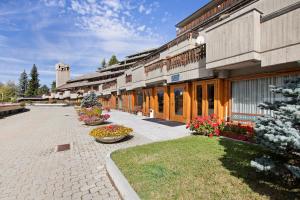 a row of buildings with flowers in front of them at Augusta Praetoria Pila in Gressan