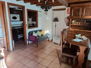 a living room with a couch and a table at La Casina Del Fornu in Pravia