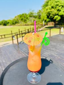 a drink with an umbrella and a pair of scissors at THE GALAXY FOREST LODGE in Manguzi