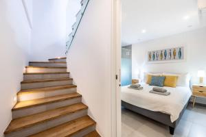 a bedroom with stairs leading up to a bed at Casa Machado in Lagos