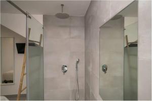 a shower with a glass door in a bathroom at Casa Machado in Lagos +27 photos