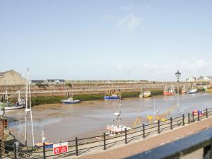 a group of boats in a river with a bridge at Alauna View in Maryport