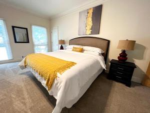 a bedroom with a large bed with a yellow blanket at 2811 Hawthorne Dr, NE in Atlanta