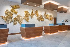 a lobby with brown and blue desks and gold decorations at The Royal Sonesta Washington DC Capitol Hill in Washington