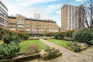 a garden in the middle of a building with buildings at Charming Apartment in the Pleydell Estate in London