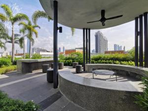 un patio con una panca, un tavolo e un ventilatore di Trion KL High floor Corner Unit Free Parking Near TRX KL Centre and MRT a Kuala Lumpur
