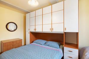 a bedroom with a bed and white cabinets at Augusta Praetoria Aosta in Aosta