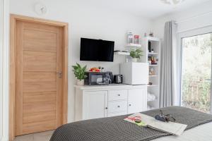 a bedroom with a bed and a tv on a wall at Siskin Guest Suite in Kinrara