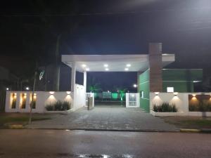 a house with a parking lot at night at Brejatuba Residence! Conforto e lazer em excelente condomínio in Guaratuba