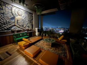 a living room with a statue of a buddha at Luxury Penthouse with Taj Mahal view in Agra