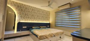 a bedroom with a bed and a window with blinds at 1BHK LUXURY APARTMENT- Palayam in Trivandrum +31 photos