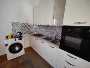 a kitchen with a washing machine and a washer at Casa Titì in Cefalù +40 photos