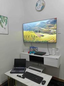 a desk with a computer and a monitor and a keyboard at Chelsea Suite's Esthetic Staycation at Trees Residence QC in Manila