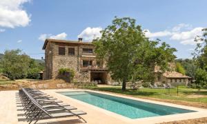 une villa avec une piscine en face d'une maison dans l'établissement La Caseta, à Sant Jaume de Llierca
