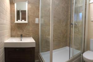 a bathroom with a shower and a sink and a toilet at Black Horse Hotel in Grassington