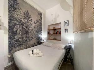 a bedroom with a bed with two towels on it at Modern Apartment Nice Old Town in Nice