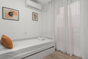 a white room with a bed and a window at Los Boliches comfy retreat - Ref 229 in Las Lagunas Mijas
