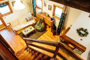 an overhead view of a living room with a bench at Chaletbethere in Pila