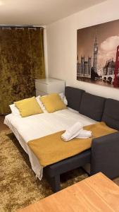 a bedroom with a bed with yellow pillows at Self contained 2 Bedroom flat in Southwark in London