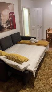 a bed with two pillows on it in a room at Self contained 2 Bedroom flat in Southwark in London