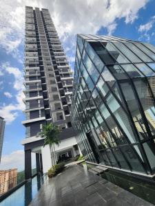 a tall building with a pool in front of it at Urban Suite - George Town in Jelutong