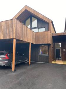 a house with a car parked in a parking lot at Nordheim Studio Apartment in Tromsø