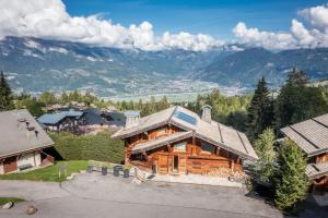 an overhead view of a log home with mountains in the background at Chalet Purdey Combloux - BY EMERALD STAY in Combloux