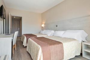 Postel nebo postele na pokoji v ubytování Hotel Best Negresco